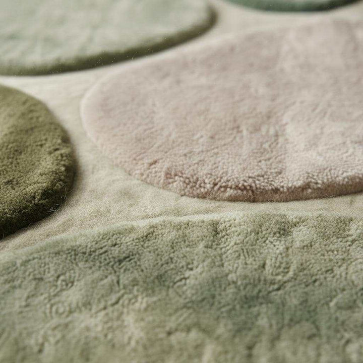 Translation missing: es.Organic modern area rug with sculpted pebble pattern and green neutral tones for nursery and living room decor
