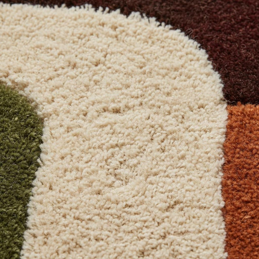 Translation missing: en.Close-up detail of a handmade tufted rug showing textured wool and stitching
