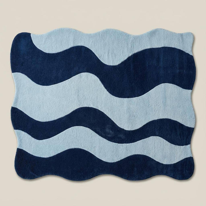 Translation missing: en.Soft plush wavy rug in two-tone blue color palette featured on herringbone wood flooring for modern home decor