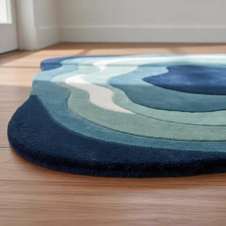 Translation missing: en.Modern accent rug with sculpted wavy pattern and multi-tone blue design enhancing a cozy living room with natural light and plants