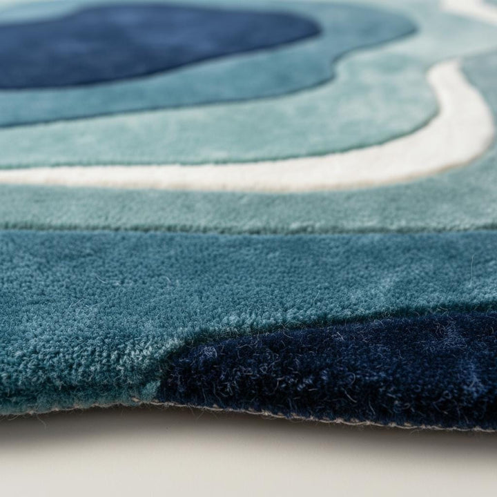 Translation missing: en.Close-up detail of a handmade tufted rug showing textured wool and stitching
