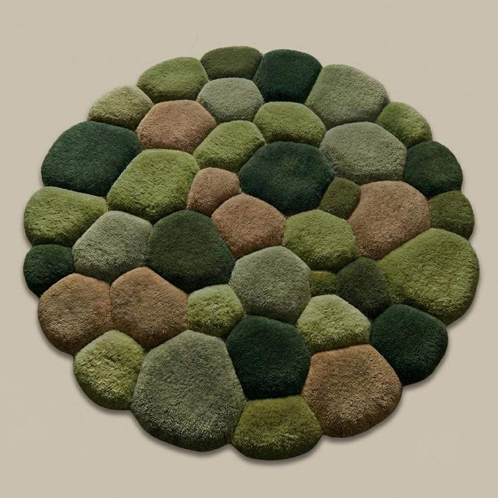 Translation missing: en.Unique textured moss rug with sculpted pebble design on a smooth concrete floor, perfect for cozy natural home décor