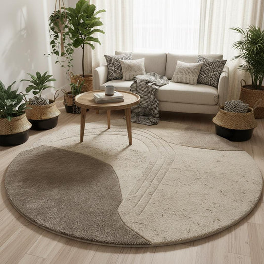 Translation missing: es.Minimalist neutral round area rug with sculpted design, shown in a bright living space with classic wall paneling and a mid-century wood chair