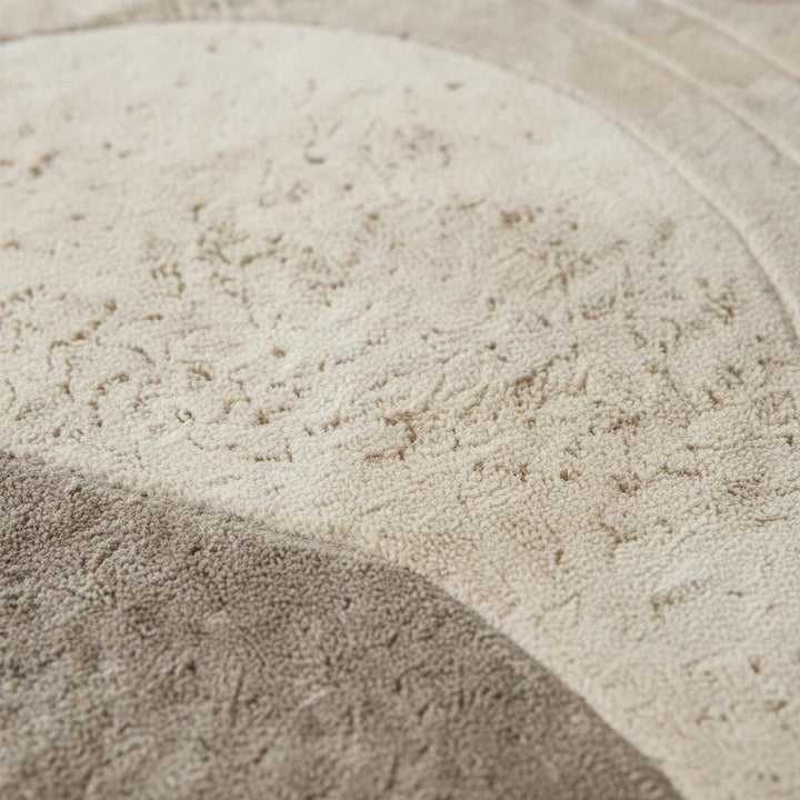 Translation missing: es.Round sculpted wool rug with textured surface in neutral beige for minimalist living room decor