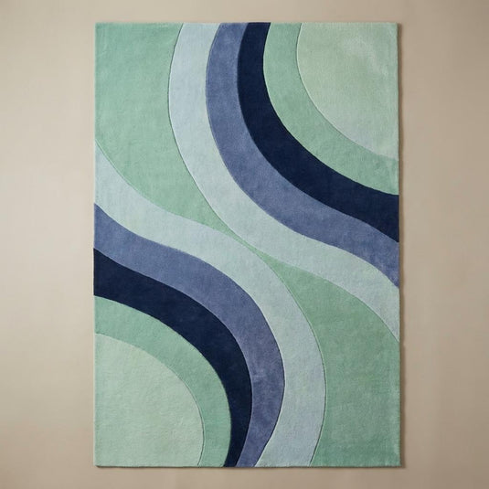 Translation missing: es.Contemporary mint and blue curved-pattern rug under a navy armchair, perfect for modern or mid-century home décor