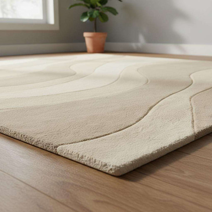 Translation missing: en.Minimalist beige and cream rug with elegant wavy lines adding warmth and texture to a serene living room space