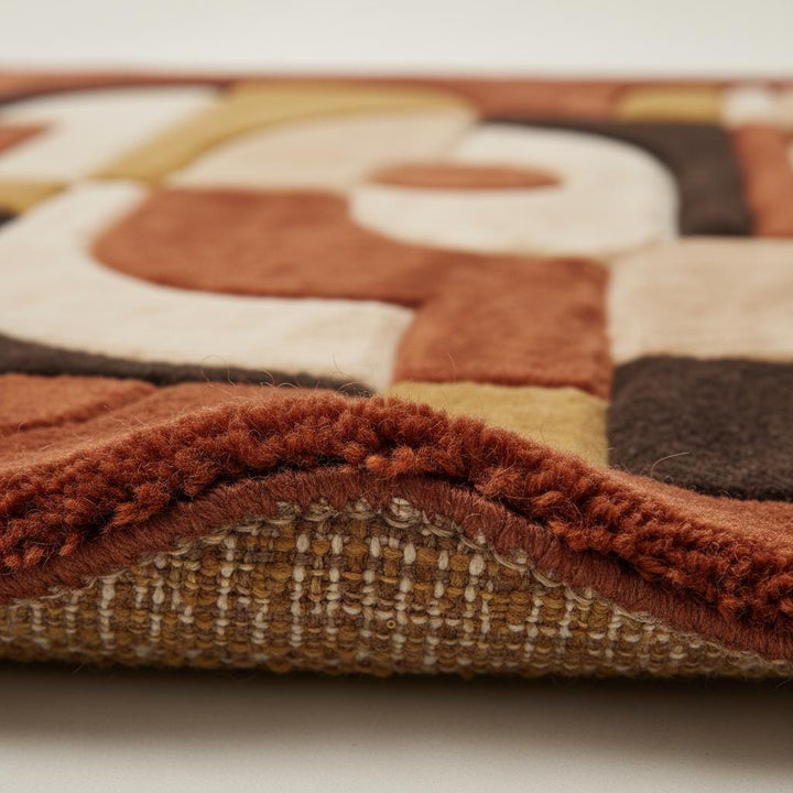 Translation missing: en.Close up of abstract geometric rug texture showing thick tufted pile, sculpted curves, and plush fibers highlighting craftsmanship and premium material quality