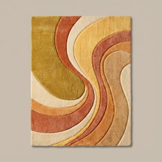 Translation missing: en.Top-down view of abstract mid century modern rug with curved wave design, warm earth tone palette, and clean rectangular shape displayed on wood flooring