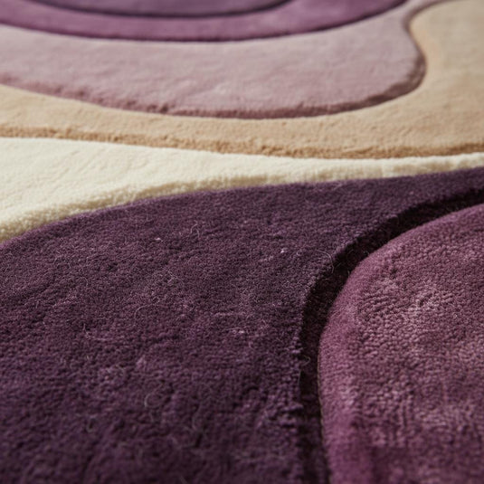 Translation missing: en.Close-up of plush abstract rug texture showing soft dense fibers, smooth pile finish, and layered color transitions in mauve, plum, beige, and cream tones