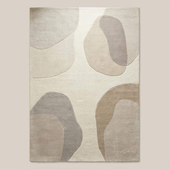 Translation missing: es.Top-down view of abstract area rug displaying full organic shape pattern, neutral beige and cream color palette, and balanced modern design suitable for contemporary interiors